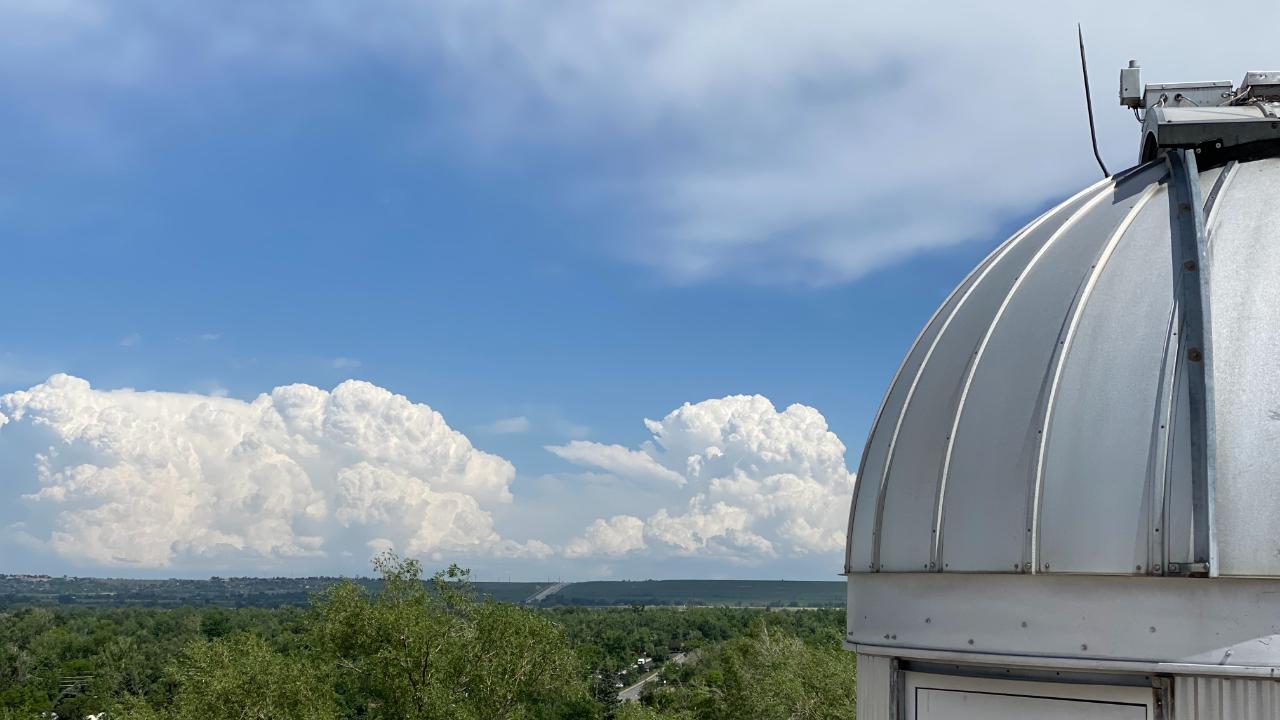 NOAA Dobson Dome on top of the DSRC with Thunderstorms in the background