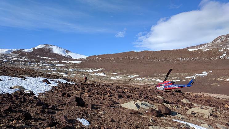 helicopter and man in remote mountain range