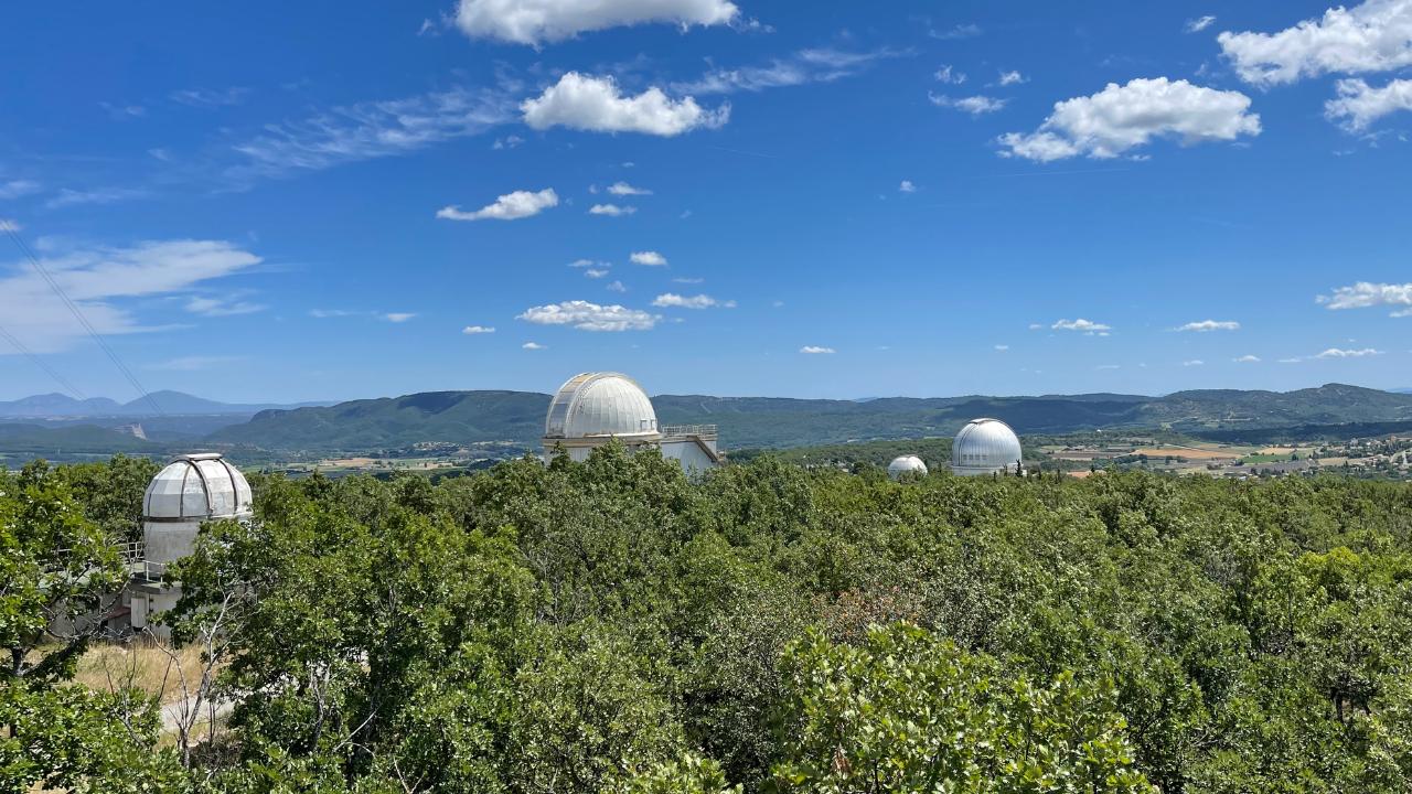 Observatory domes on a hill with sunny skies